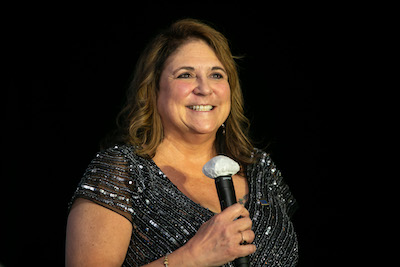 Janet Judd holding a microphone